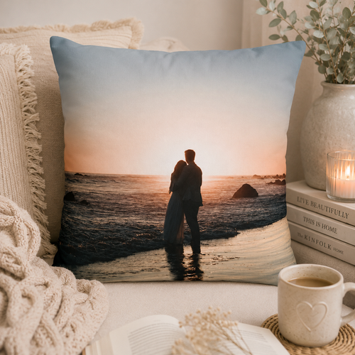 Personalised photo pillow cover lifestyle mockup – couple sunset pillow on cozy armchair with candle and books